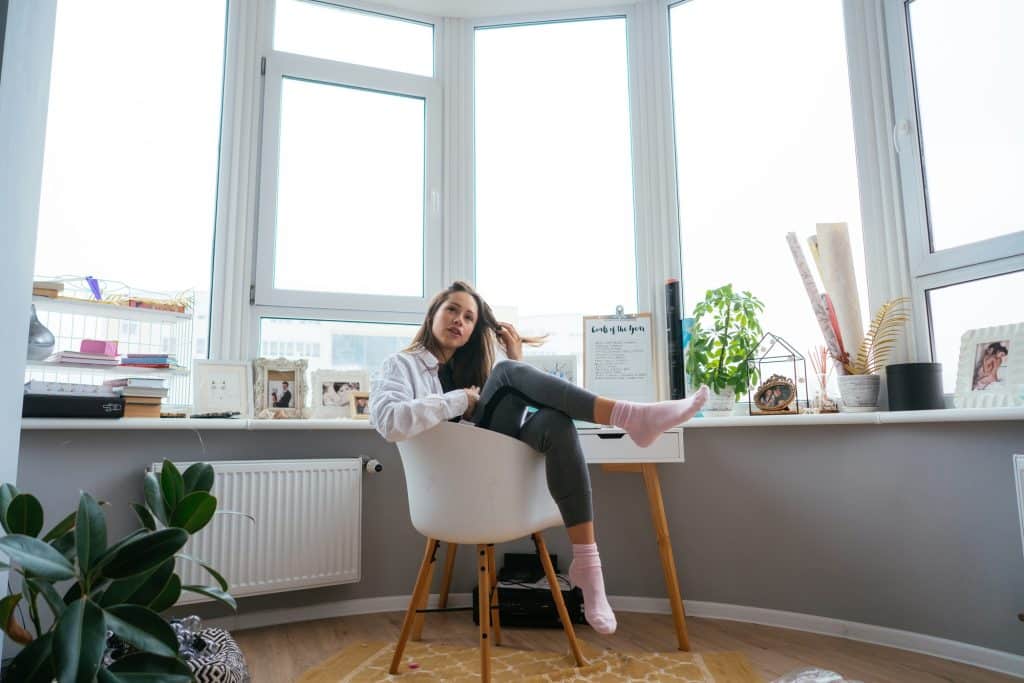 Young woman on chair near the window