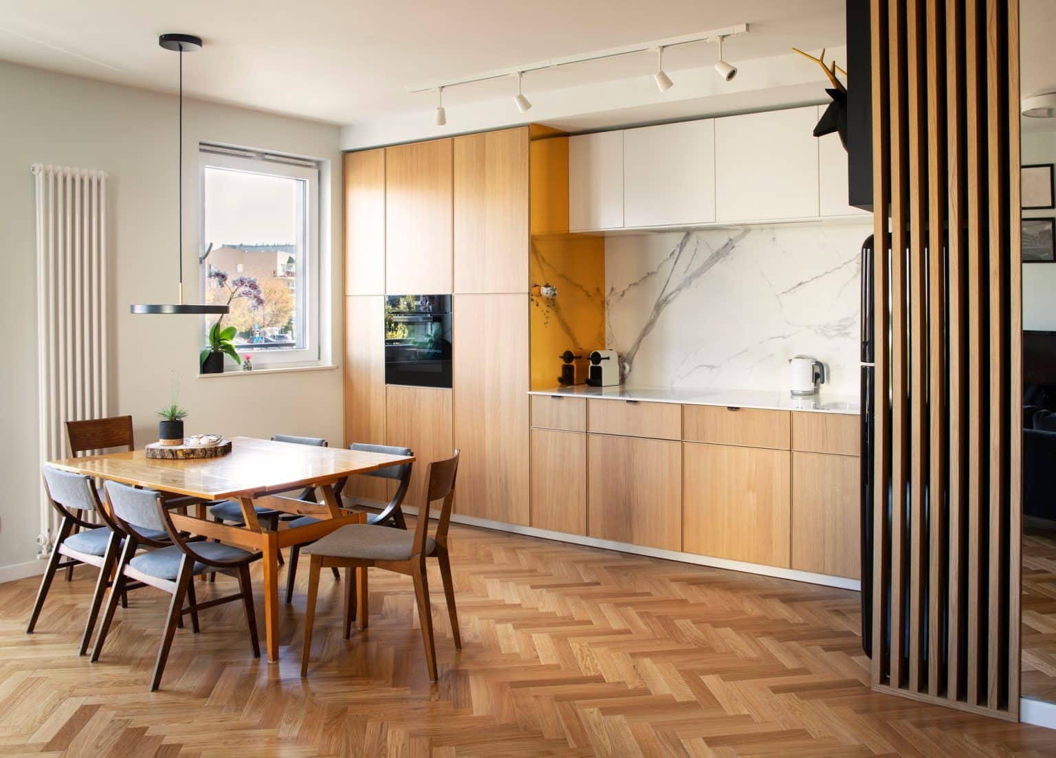 Stylish scandinavian open space interior of kitchen and dining room.